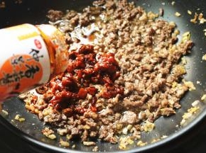 剩余几分钟的时候，打开锅盖，程序会自动停止，加入一整瓶奥尔良口味的香菇酱。