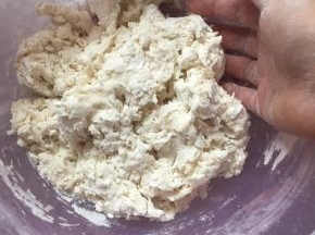 一点点倒入水，边用筷子搅拌成小片状。无干粉的时候用手揉成团。