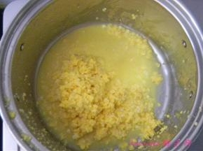 擦好的玉米碎放入煮锅里；