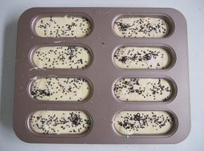 在蛋糕糊表面撒上剩余的椰蓉，再撒上一层黑芝麻。中下层上下火，30分钟左右熟透即可，烤好后出炉震一下，倒扣晾凉后脱模