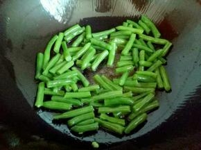 锅中加入油，油温8成时加入焯过水的刀豆煸炒，约2分钟，刀豆表面有些打皱。