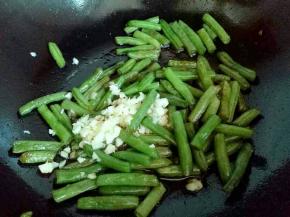 加入切碎的蒜末继续大火煸炒，把刀豆炒熟。