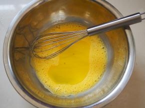 鸡蛋分离蛋清和蛋黄，蛋黄放入盆中打散，加入玉米油搅拌均匀后加入牛奶继续搅拌均匀