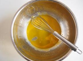 蛋黄中加入玉米油，充分搅拌均匀