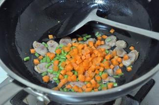 倒入胡萝卜、豇豆，翻炒2分钟。