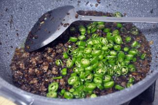 倒入青椒，继续翻炒。