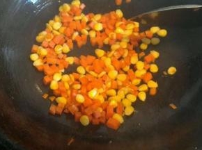 锅内放入适量油  将胡萝卜丁和玉米粒炒熟盛出备用
