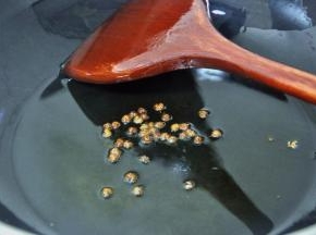 此时锅中留下少量的油，倒入花椒。