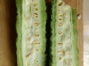 首先苦瓜一切二，也就是从苦瓜的中间切开。