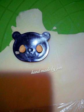 再把白色面团擀平，压熊猫的眼睛