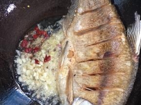 把多余的油倒出来，只留少许底油，放入生姜，蒜瓣，干辣椒，花椒小火炸出香味儿来！
