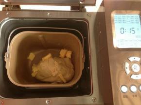 选择和面10分钟，静置5分钟后加入切成小块的软化黄油，再选择和面程序15分钟