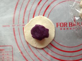将大面团擀成中间厚两边簿的面片，中间放入15克的紫薯馅