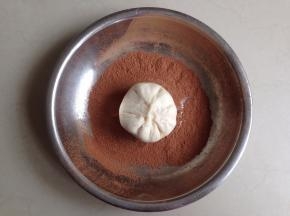 将光滑的一面放入到装有可可粉的盘里，使表面和侧面都粘上可可粉
