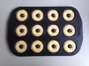 将冷藏过的蛋糕糊装进裱花袋，再挤入甜甜圈蛋糕模里