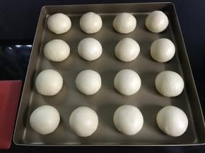 滚圆后码入烤盘中。