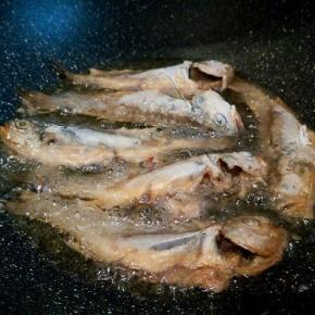  锅里放适量油，油温用筷子试一下，筷子周围冒小泡泡就可以中火炸了！梅鱼底下定型再翻面，