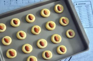 放入整颗的杏仁，轻轻的压一下，表面刷上少量的蛋液。