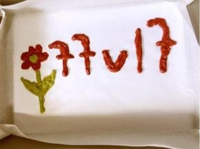 裱花袋剪一个小口，把刚才画好的文字和图案填满！


