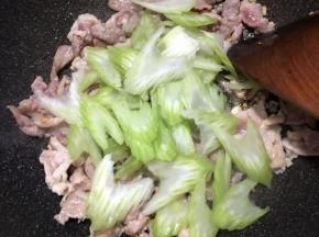 炒至肉片微白，下入西芹不停翻炒。