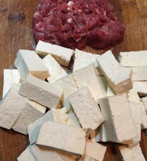 豆腐切小块，前腿肉剁碎。