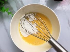 蛋液里加入20克糖粉，打散至糖粉融化，（一个大大的鸡蛋大概有60克左右，小的只有30多克，所以称出58克的剩余的蛋液最后可用刷表面