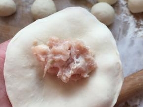 用擀面杖擀成面皮，包入馅料褶好