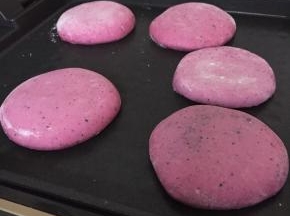 收口处朝下按扁，放入电饼档，不需要放油，煎好一面翻过来煎另一面煎熟