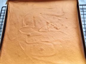 烤盘放入已预热到位的烤箱中层，烘烤20分钟，烤好取出烤盘，在台面上震几下，烤盘倒扣在已铺油纸的烤架上放凉