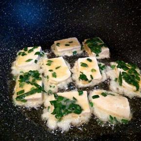 不粘锅倒油3勺，手放在上面，微微有点热了，就可以放豆腐煎，先不要去翻它，等定型以后翻面煎，