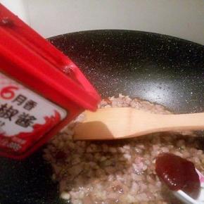 肉丁变色以后，加花椒，大料十三香翻炒片刻，加辣椒酱1勺翻炒，