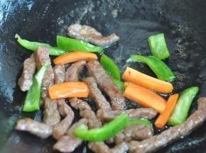 放入胡萝卜段和青椒段。