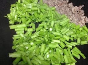 肉末变色后加入空心菜梗翻炒