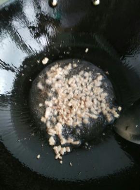 锅里放适量的油，小火加热。放入肉丁翻炒