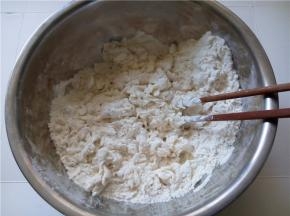 慢慢的加入，用筷子搅拌成松散的颗粒状。