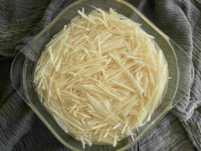 先将土豆切成丝，然后放入水盆中泡10分钟左右。