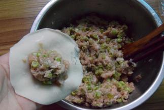 取饺子皮，放上适量肉馅包饺子