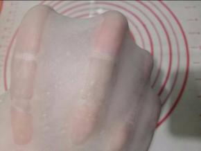 揉到面团光滑放软化的黄油,直到揉出手膜.