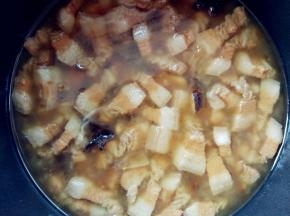 大约30分钟，完成后连汤带肉倒入铁锅中。这时肥肉部分已经入口即化，不用嚼，舌头一压就碎得滑溜溜的了