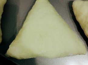 依次做好6个三角包，放入烤盘进行二发，现在夏天，室温三十几度，所以我直接室温发酵，约40分钟