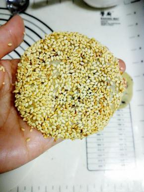 两面刷上清水，并均匀的粘上熟白芝麻