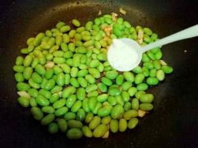 毛豆炒至外皮打皱时加入盐，糖。