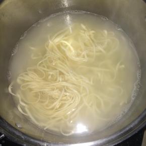 开水煮熟面条。