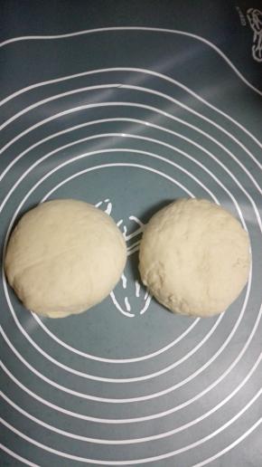 取出发酵好的面团，揉匀排气后，分成2份，盖上保鲜膜，静置10分钟