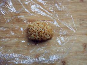 取适量酱油炒饭，放入保鲜膜中，捏出小鼠头部的形状