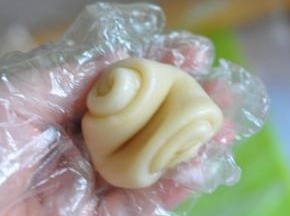 取一个面条，从中间压下，将头尾压进去滚圆。