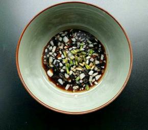 然后往蒜泥汁中加入味极鲜、醋、白糖、香油、鸡精、小葱搅拌均匀