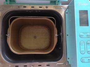 之后将米放进面包桶内加水。