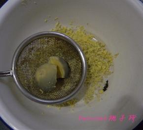 煮熟2个鸡蛋，取蛋黄放在筛网上，用手指按压，使蛋黄通过筛网，成蛋黄末；