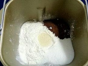 把面包用料除黄油以外的材料都放进面包机，先放液体，在放面粉，酵母放中心，盐、糖、可可粉放在三个角
